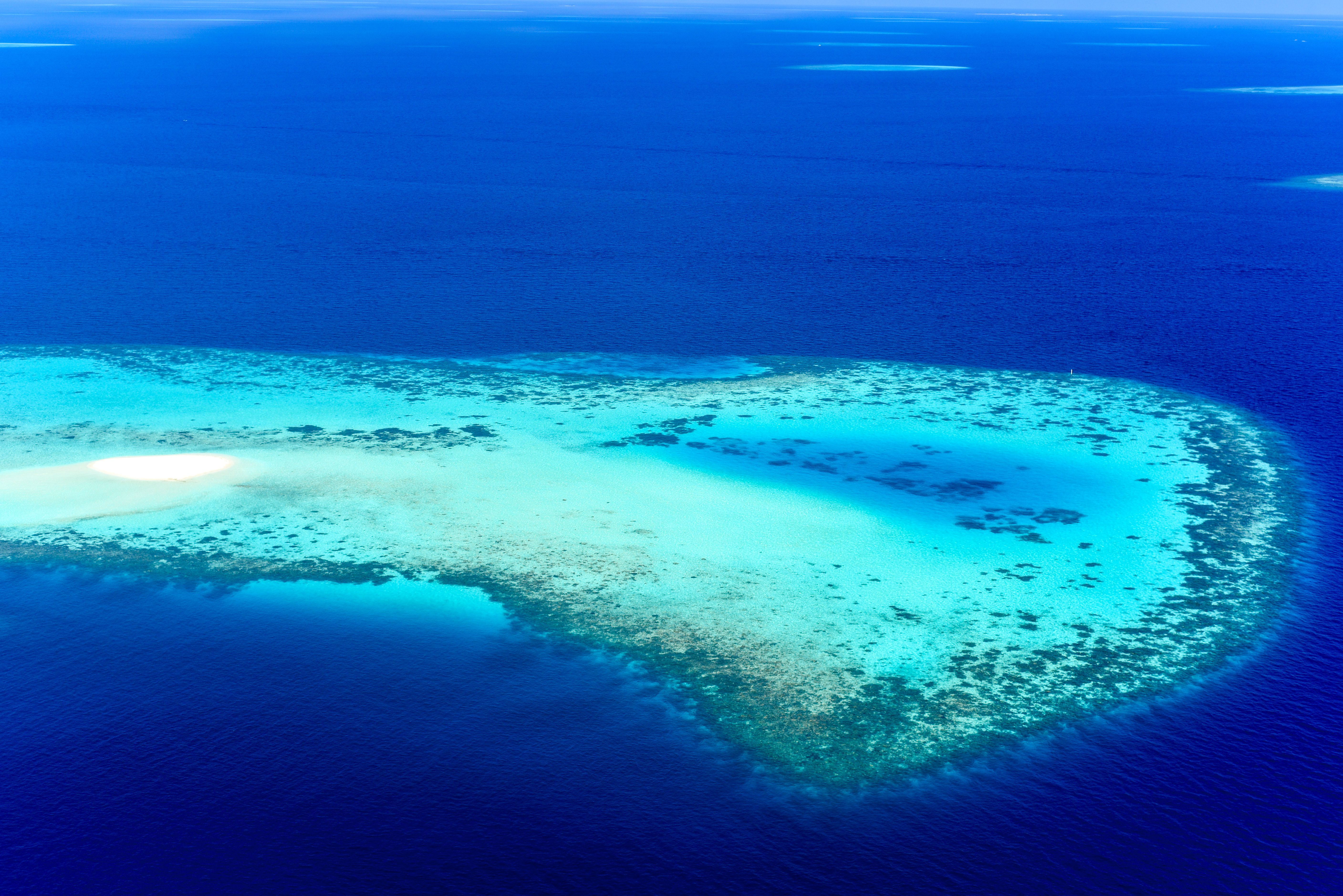 Crystal-clear turquoise lagoon surrounded by tropical atolls in the Indian Ocean
