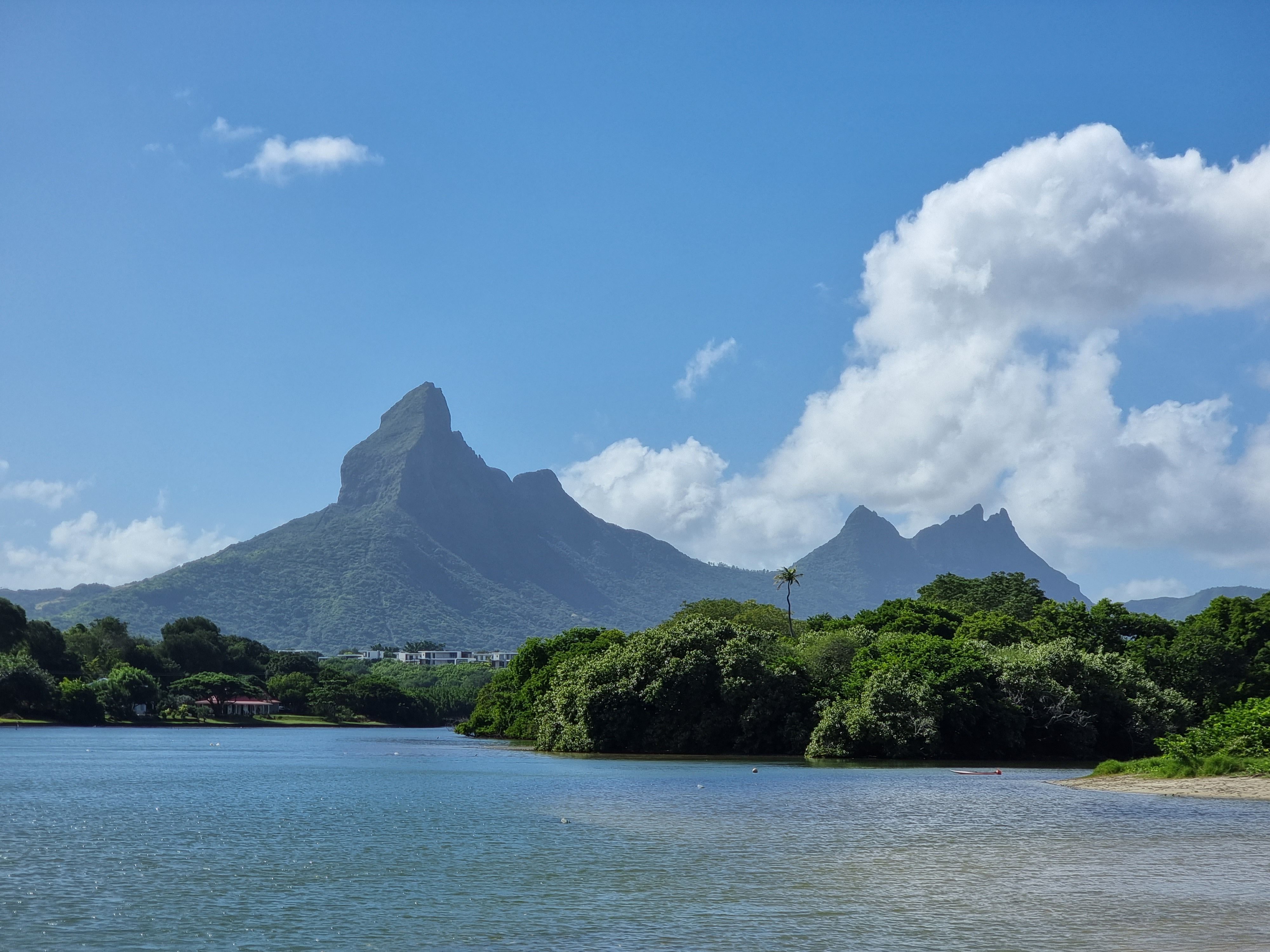 Turquoise lagoon and volcanic peaks of Mauritius with sailing yachts