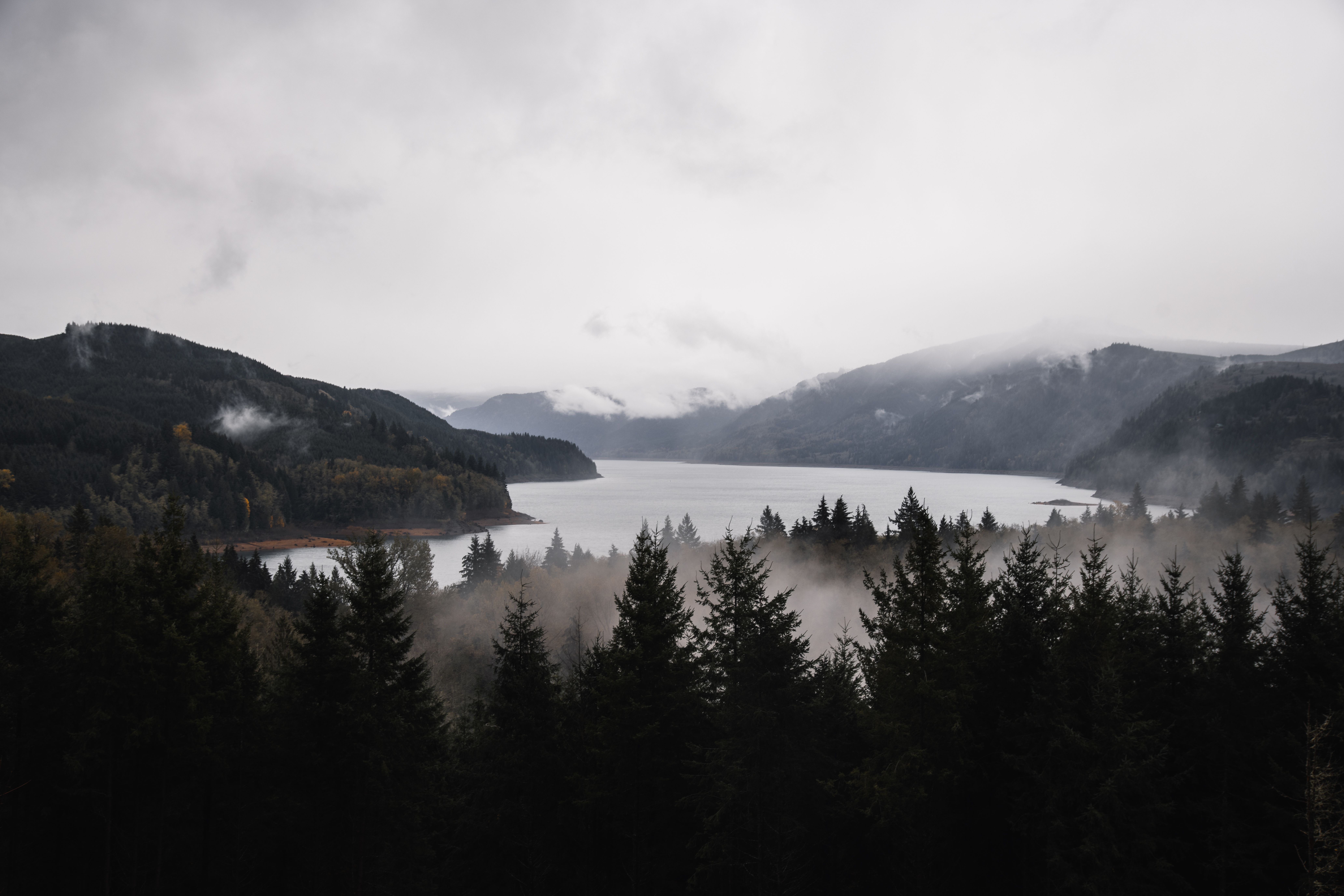 Snow-capped mountains and forested islands reflected in calm Pacific Northwest waters